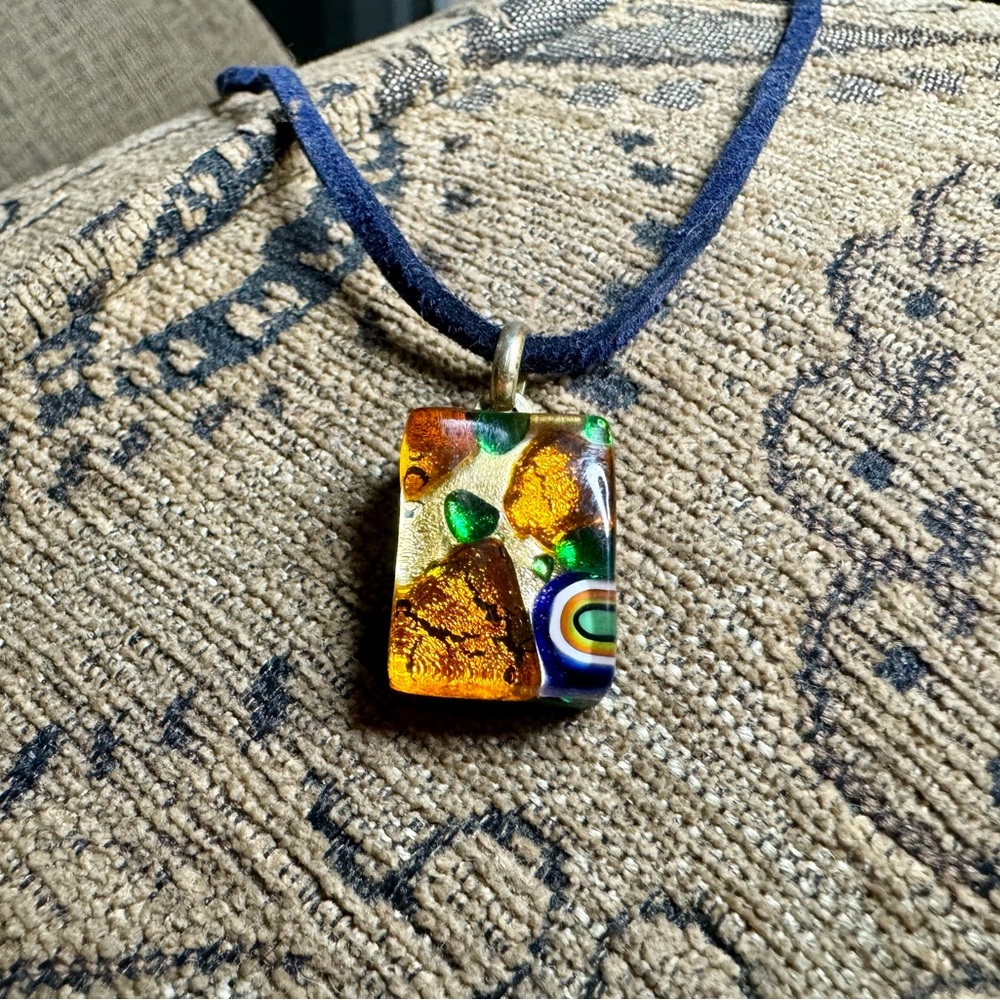 Millefiori Murano Glass pendant on a leather cord.
